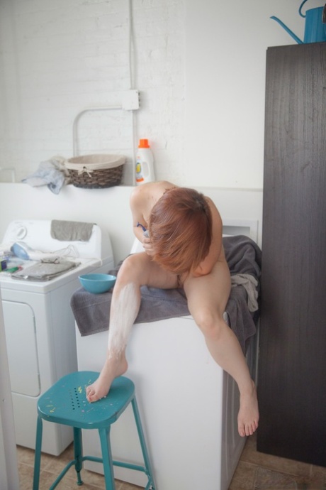 Big titted redhead Chelsea Bell shows her trimmed pussy after shaving her legs