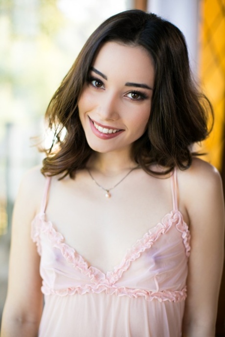Brunette teen with a pretty face Aria Lee removes sheer lingerie to pose nude