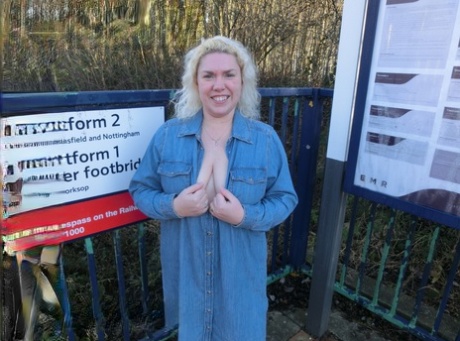 Older blonde Barby exposes her tits and pussy on a train station platform
