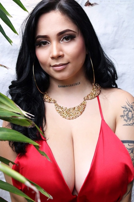Brunette Latina teen Kim Velez unveils her nice tits while going nude in heels