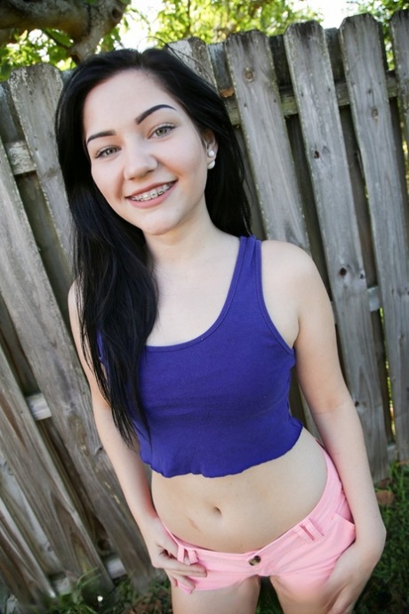 American with natural titties Karly Baker strips her shorts in a backyard