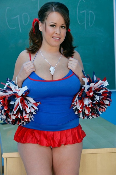 Naughty cheerleader Brandy Talore lets out her monster tits in the classroom