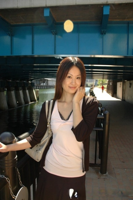 Petite Asian cutie exposes her fabulous body and poses naked in a solo