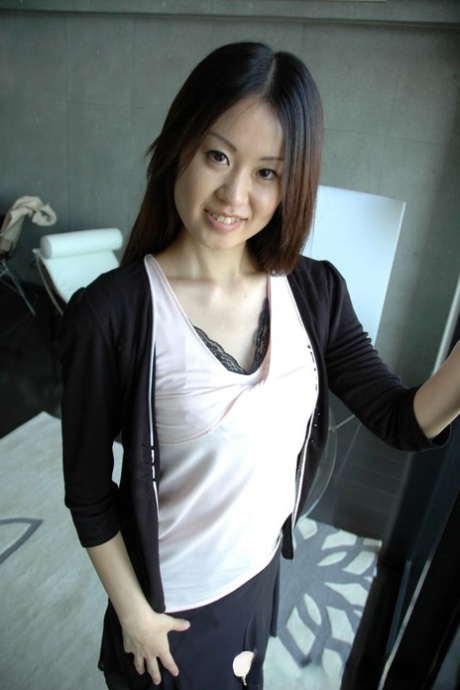 Petite Asian cutie exposes her fabulous body and poses naked in a solo