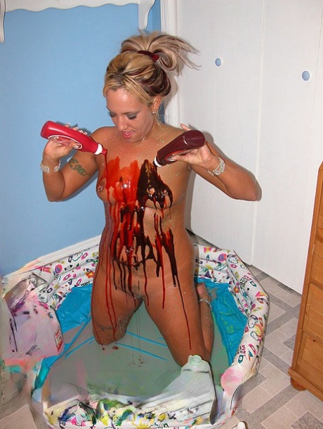 Blonde Lexxi Meyers pours milk, sauces and whipped cream all over her body