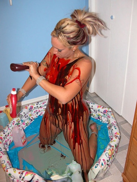 Blonde Lexxi Meyers pours milk, sauces and whipped cream all over her body