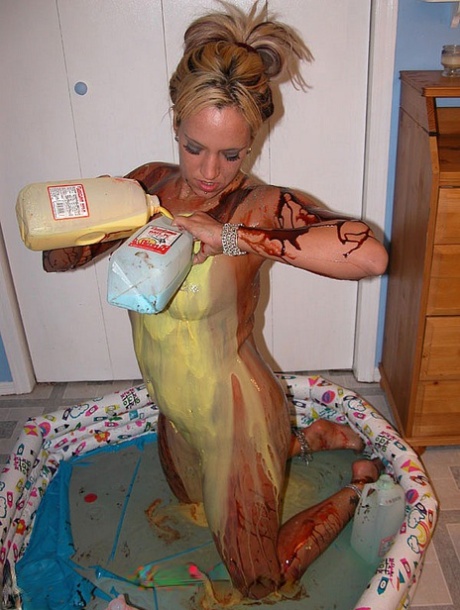 Blonde Lexxi Meyers pours milk, sauces and whipped cream all over her body