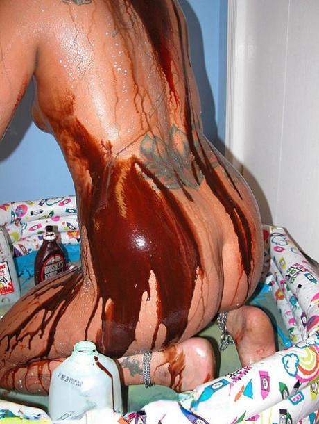 Blonde Lexxi Meyers pours milk, sauces and whipped cream all over her body