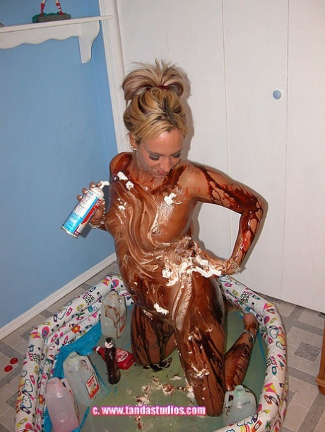 Blonde Lexxi Meyers pours milk, sauces and whipped cream all over her body