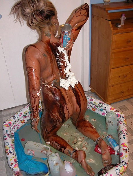 Blonde Lexxi Meyers pours milk, sauces and whipped cream all over her body